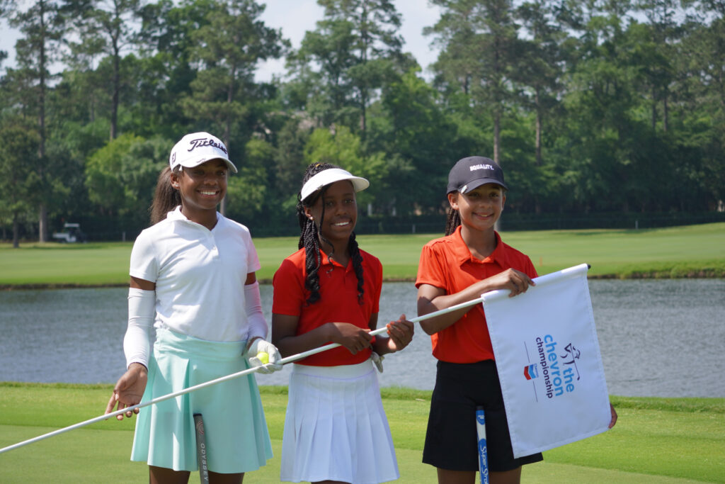 Vivian Lott, Layla Phillips and Aleah Shields-Rodipe with flagstick